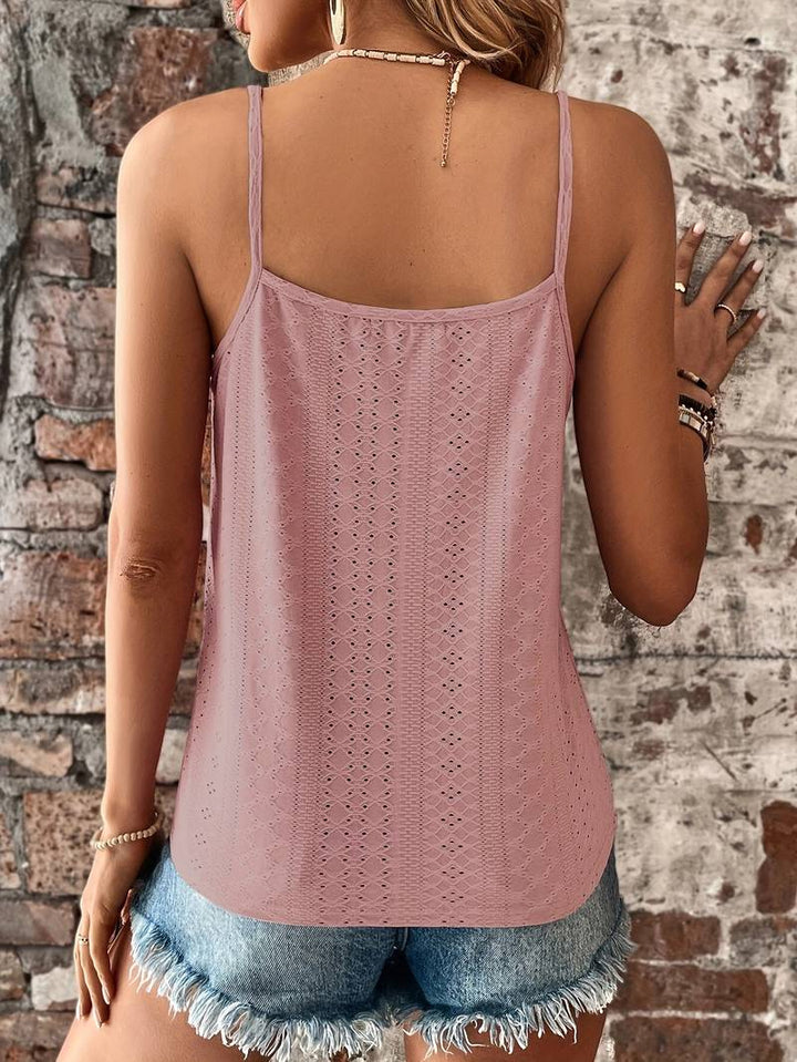 Elegant women's sleeveless V-neck top, embroidered with delicate lace accents, textured finish.