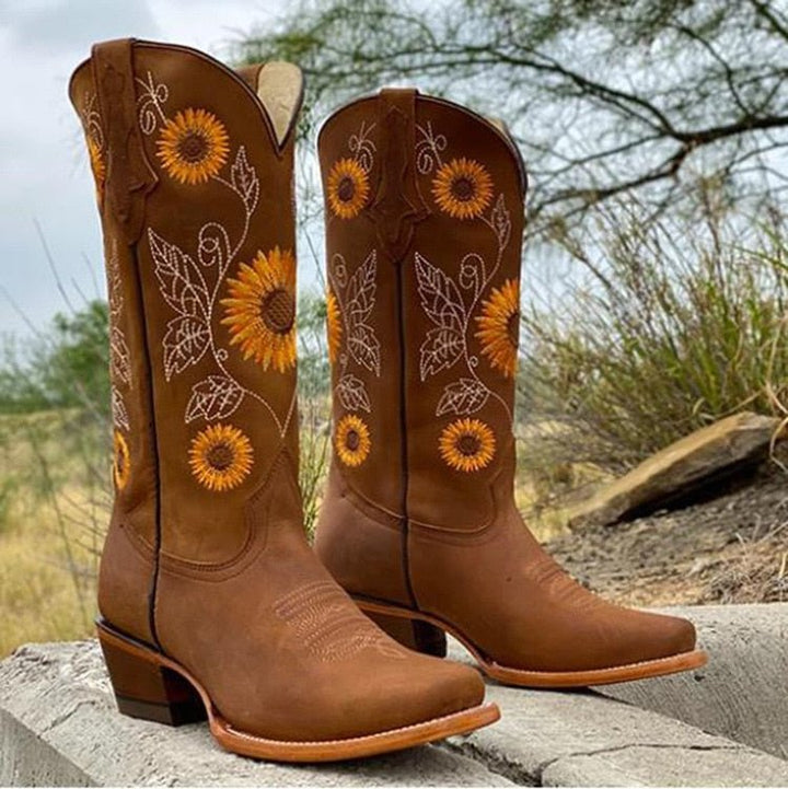 Pair of women's western boots, mid-calf height, with eye-catching sunflower embroidery and a sturdy block heel.