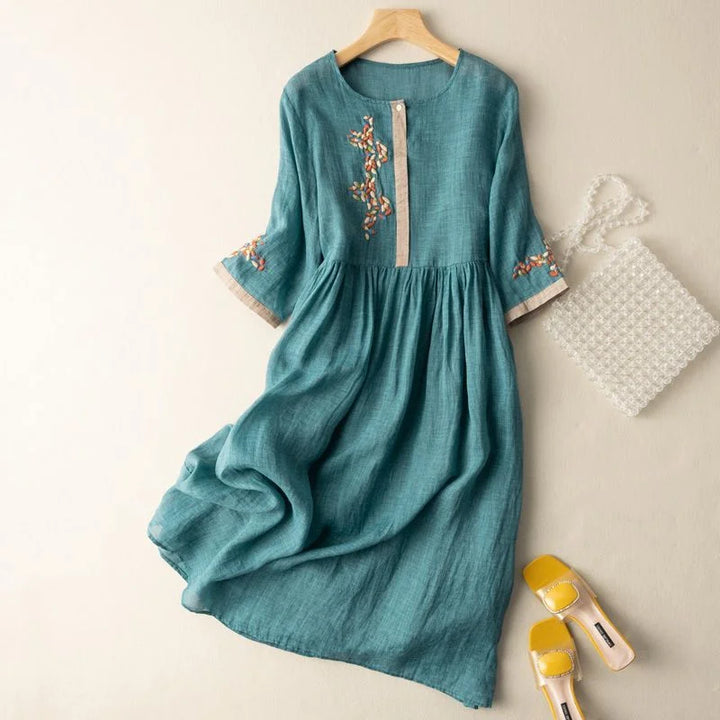 Women's embroidered relaxed midi dress with 3/4 sleeves & button placket, perfect for elegant summer wear.