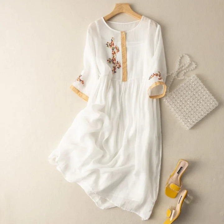 Flowy women's midi dress with relaxed fit, intricate embroidery & 3/4 sleeves for casual or vacation wear.