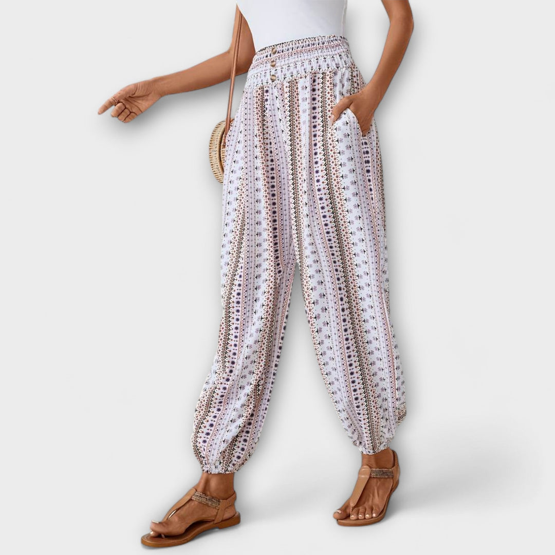Model wearing women's ethnic graphic pants, showcasing their comfortable fit & stylish design.