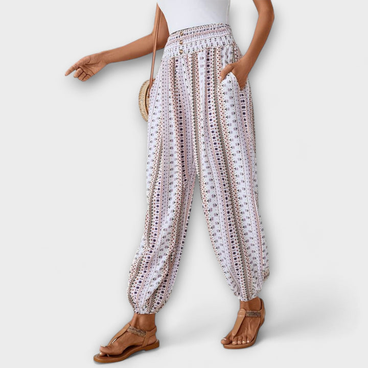 Model wearing women's ethnic graphic pants, showcasing their comfortable fit & stylish design.