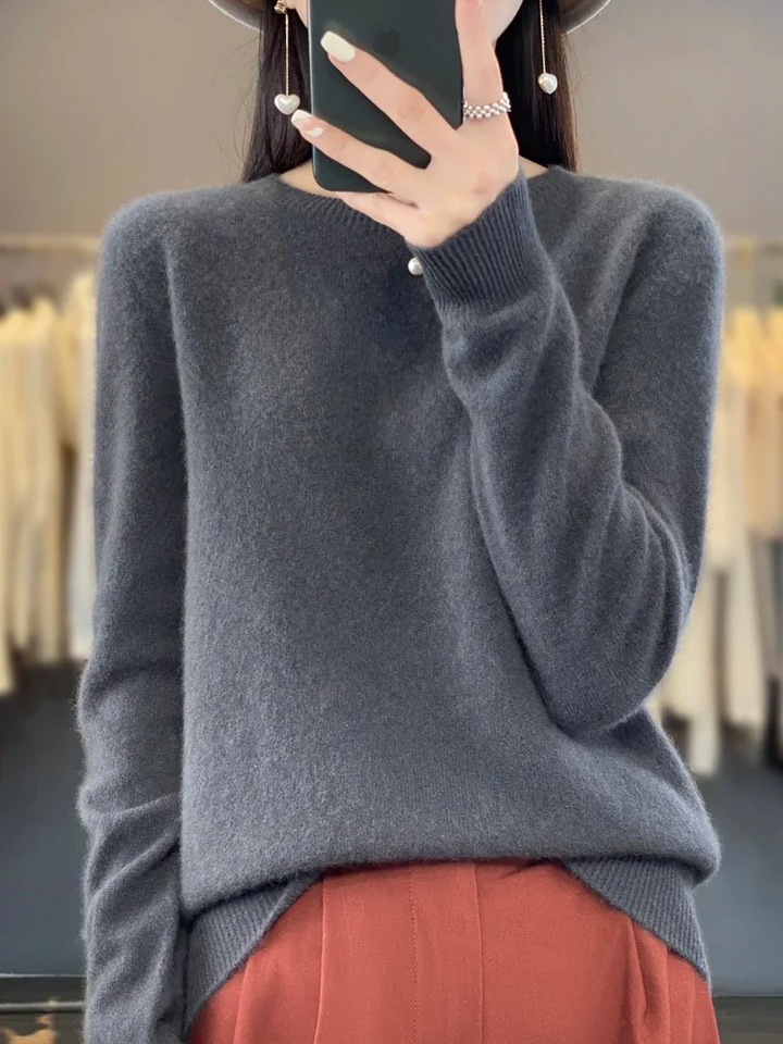 Woman wearing elegant round neck sweater, showcasing versatile everyday fashion and comfortable style.