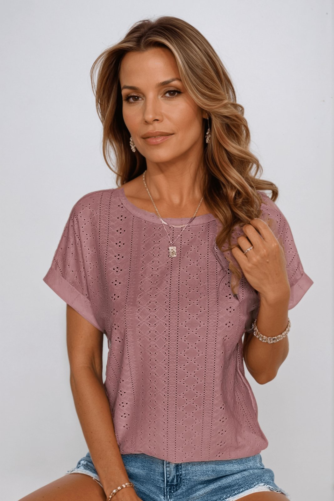 Versatile women's short sleeve eyelet top, made from breathable cotton, perfect for everyday chic summer fashion.
