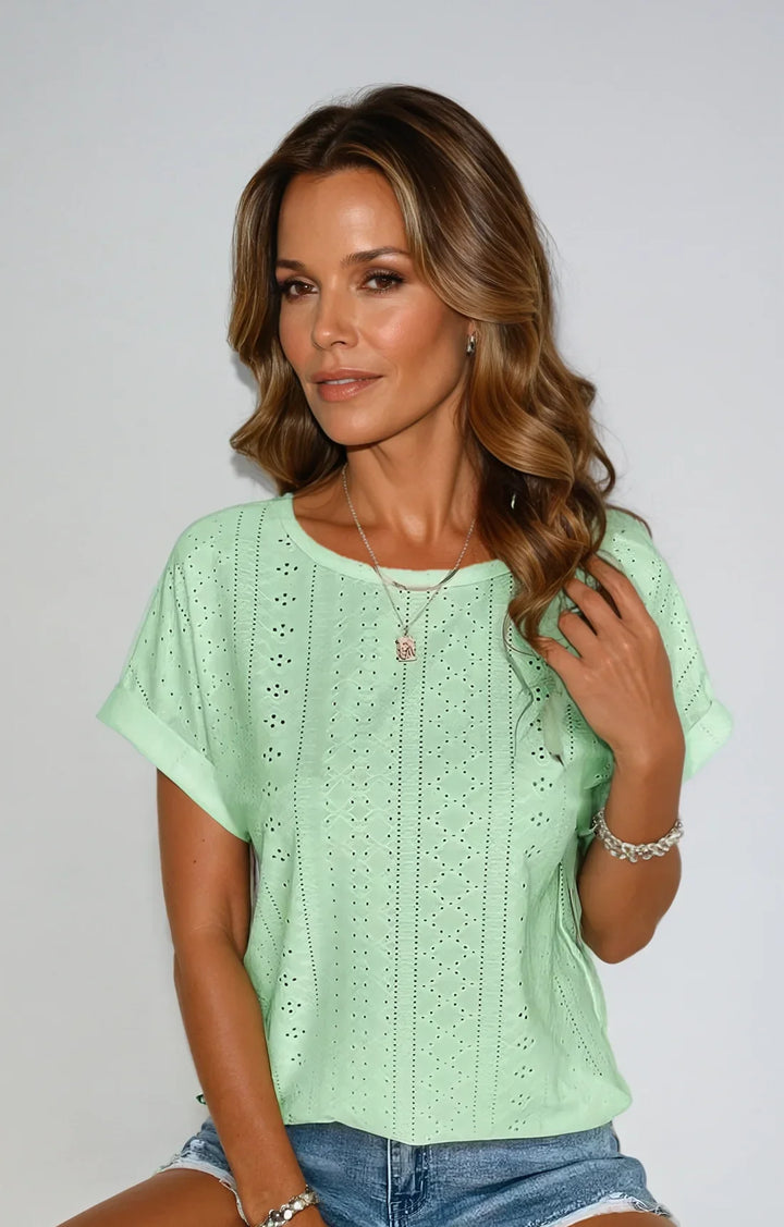 Women's short-sleeve eyelet top, cuffed sleeves & crew neck. A chic summer essential.
