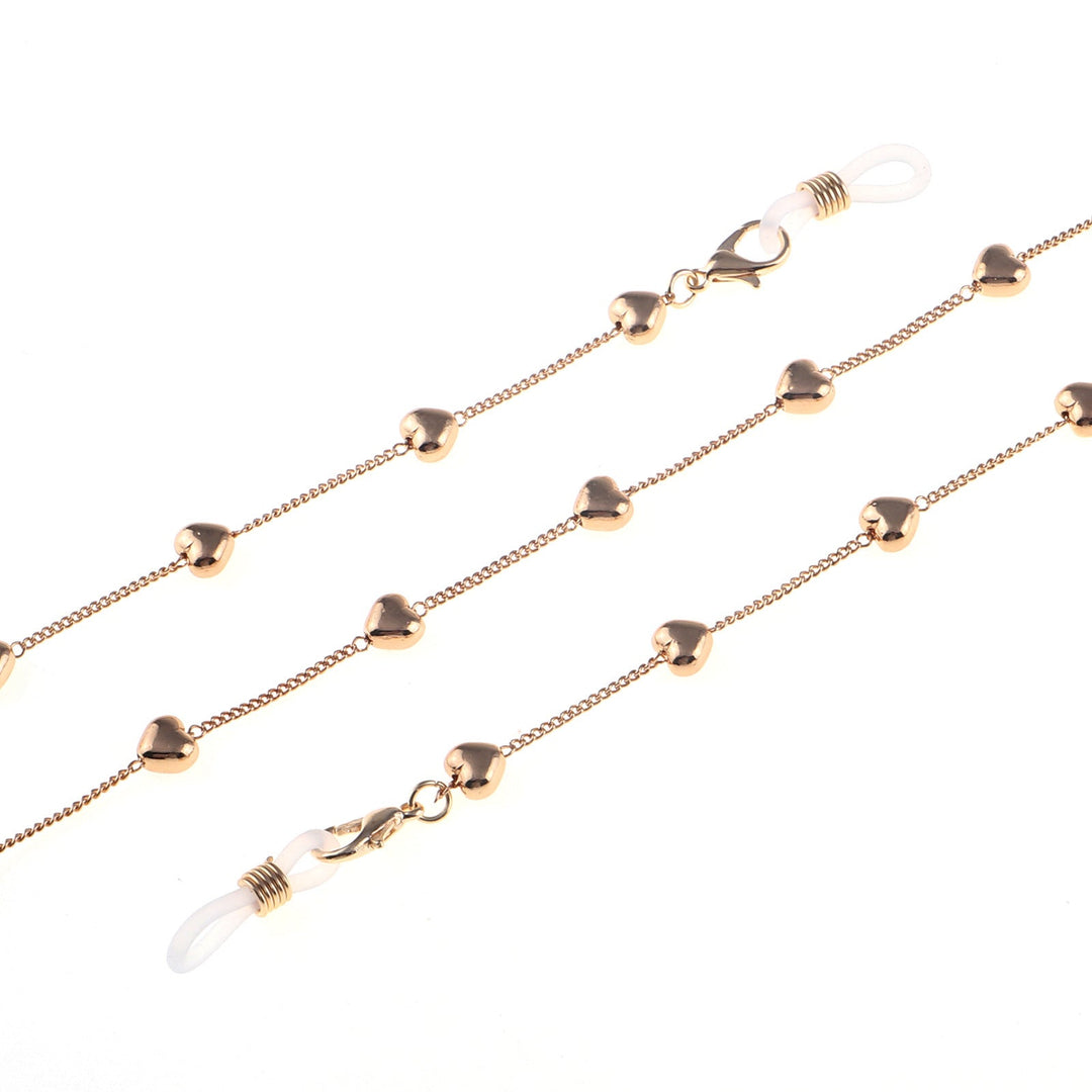 Close-up of a women's fashion glasses chain with sparkling heart pendants. Ideal stylish eyewear accessory.