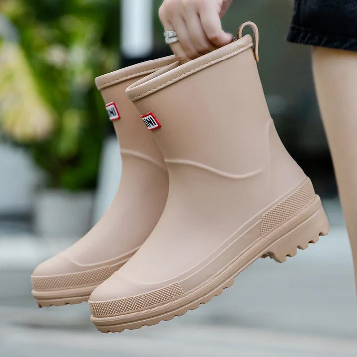 Protective & fashionable women's waterproof rain boots, keeping feet dry in style.