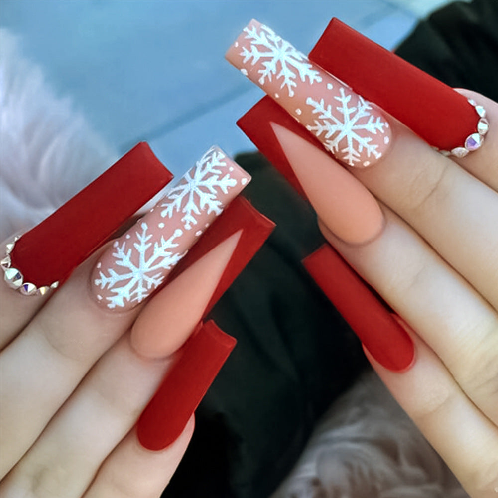 Reusable women's press-on nails for a festive holiday manicure, easy apply DIY Christmas nail art.