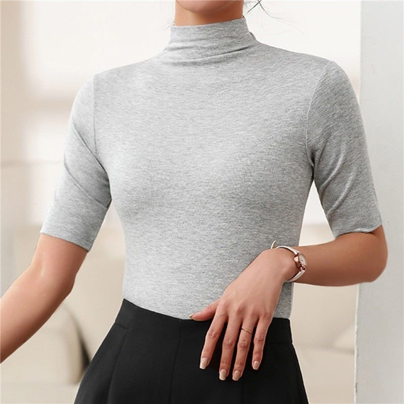 Versatile women's fitted turtleneck top with elbow sleeves. Casual chic, elegant slim fit blouse.
