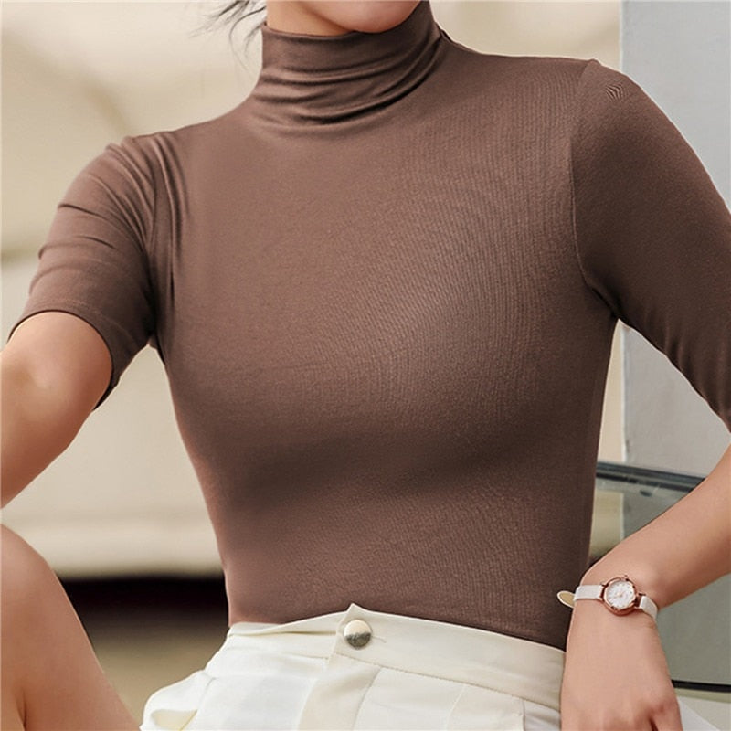 Comfortable women's fitted turtleneck elbow sleeve top. Slim fit blouse, elegant for everyday wear.