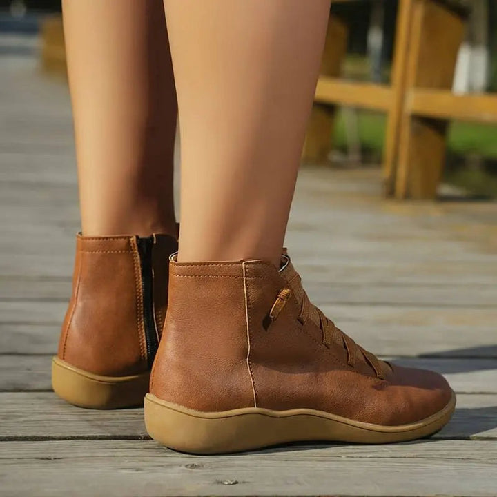 Women's flat lace-up ankle boots with side zip, offering a chic look for casual winter fashion.