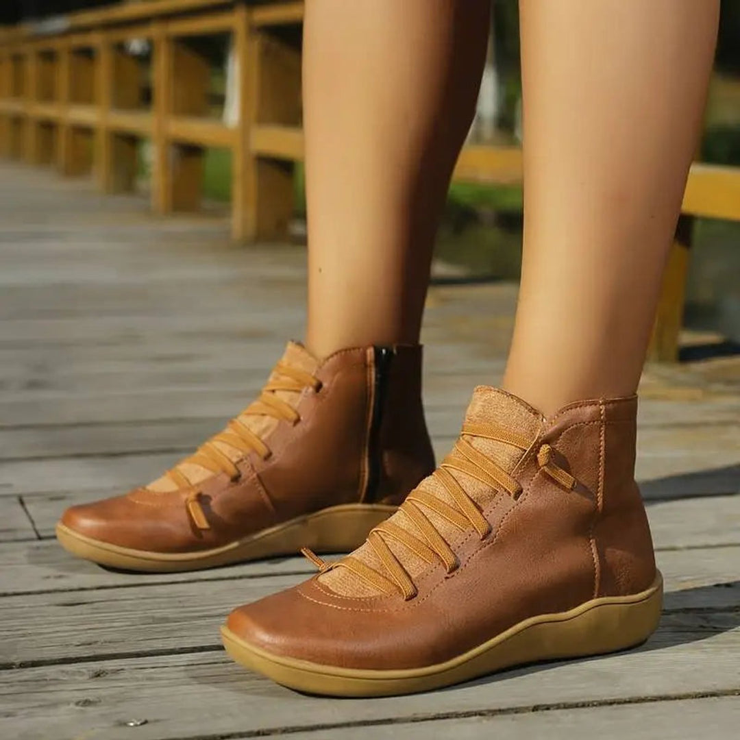 Practical women's flat side-zip ankle boots with lace-up front for a secure and comfortable fit.