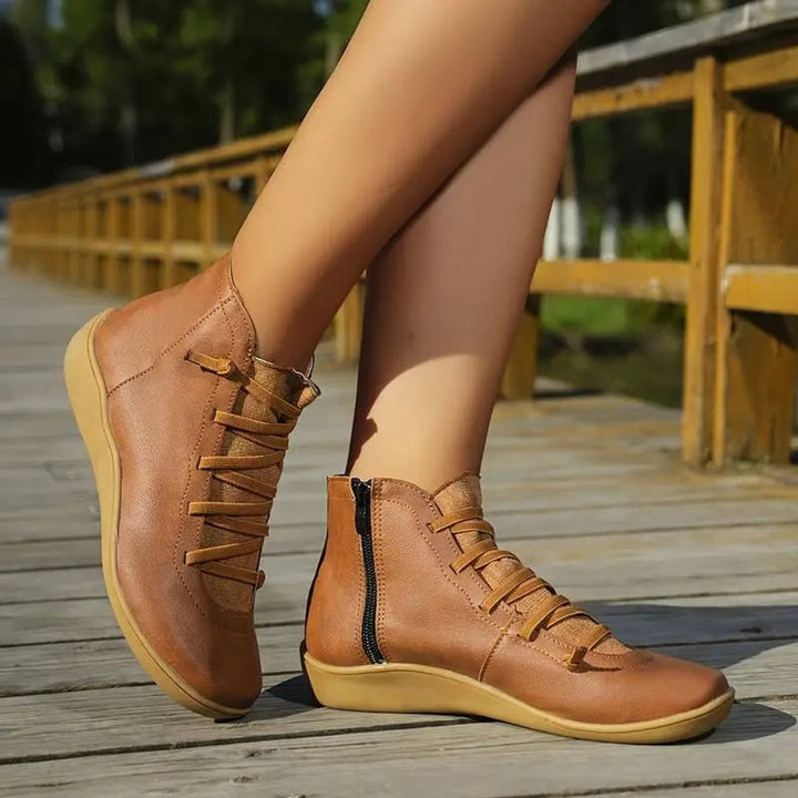 Modern women's flat lace-up ankle boots featuring convenient side-zip closure for easy wearing.