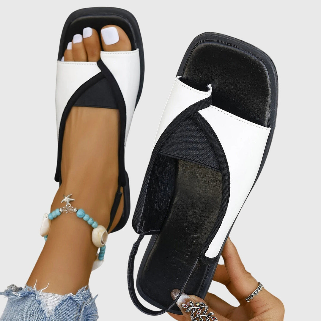 Women's flat slingback sandals with modern square toe & stylish contrast strap for summer.