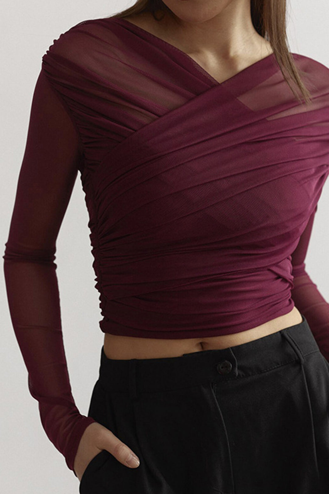 Women's flattering black ruched long sleeve top with elegant design, perfect for stylish versatile wear.