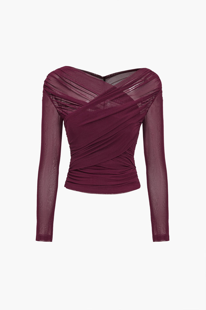 Stylish woman wearing an elegant ruched long sleeve blouse, ideal for a going out top or casual elegant look.