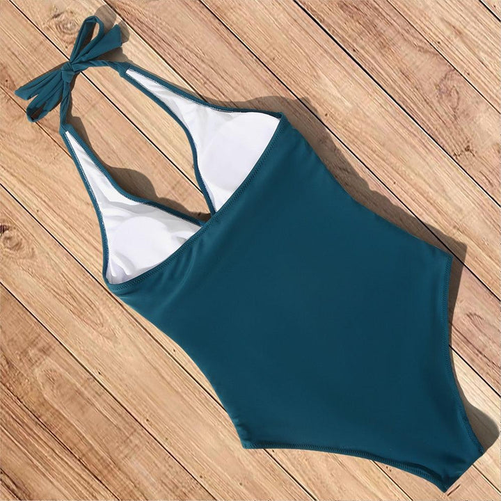 Tummy control one-piece swimsuit for women. Flattering backless design, ideal for beachwear & resort.