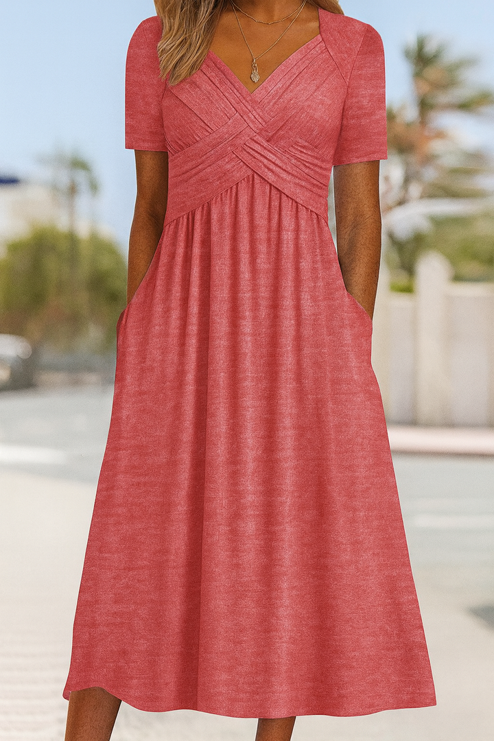 New women's short-sleeve summer dress with a chic crossed front. Ideal for casual day wear & versatile elegance.