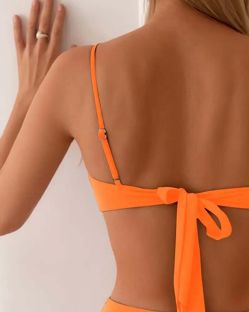 Vibrant orange women's bikini set, a flattering two-piece for your next resort getaway.
