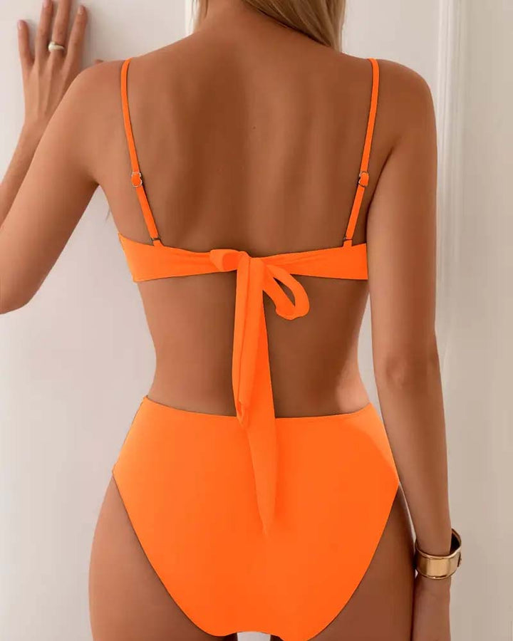 Orange women's swim set, fashionable and flattering two-piece bikini for beach vacations.