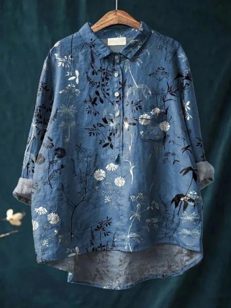 Detail shot of buttons & floral pattern on a women's relaxed fit long sleeve blouse. Elegant casual top.