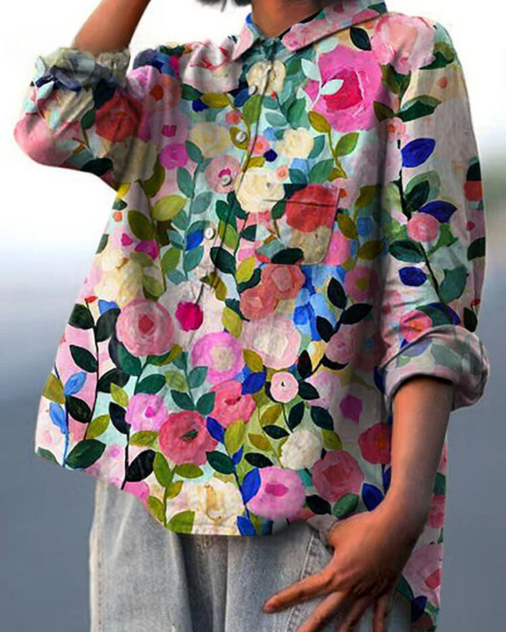 Model wears a versatile women's floral print button-up blouse. Relaxed fit, long sleeve casual top.