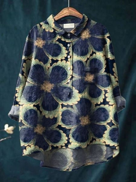 Close-up of vibrant floral print on a women's relaxed fit button-up blouse. Elegant long sleeve top.