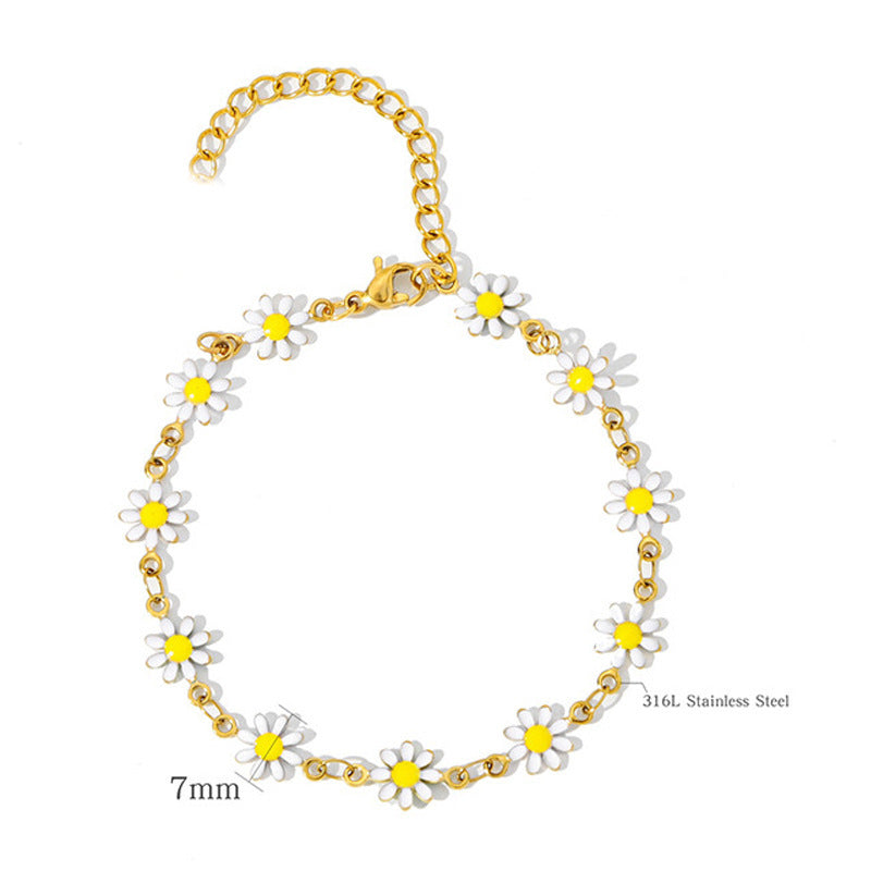 Women's colorful charm bracelet with multiple floral daisy and leaf charms, a whimsical fashion accessory.