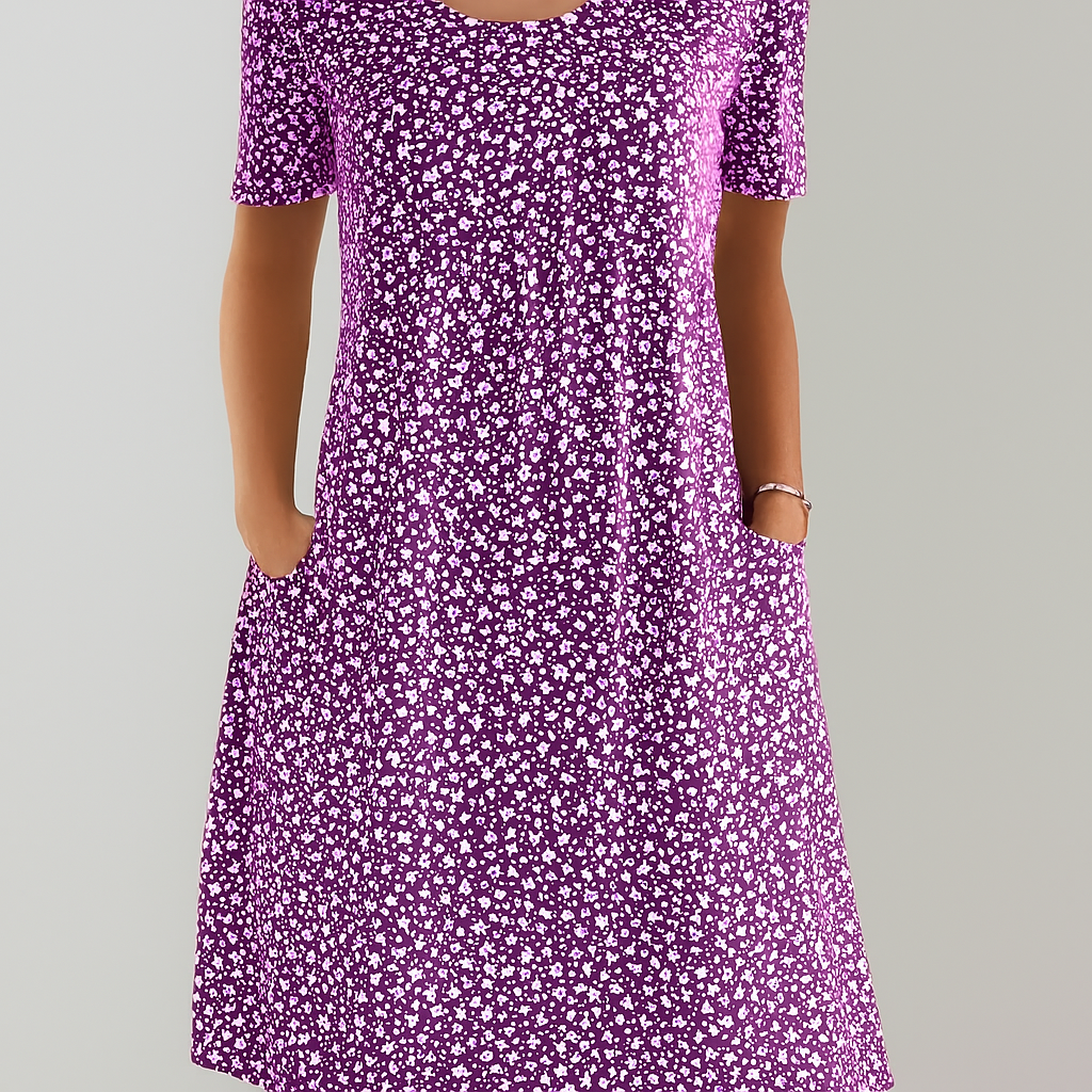 Elegant women's empire waist midi dress, featuring vibrant floral print and functional pockets. Ideal for summer.