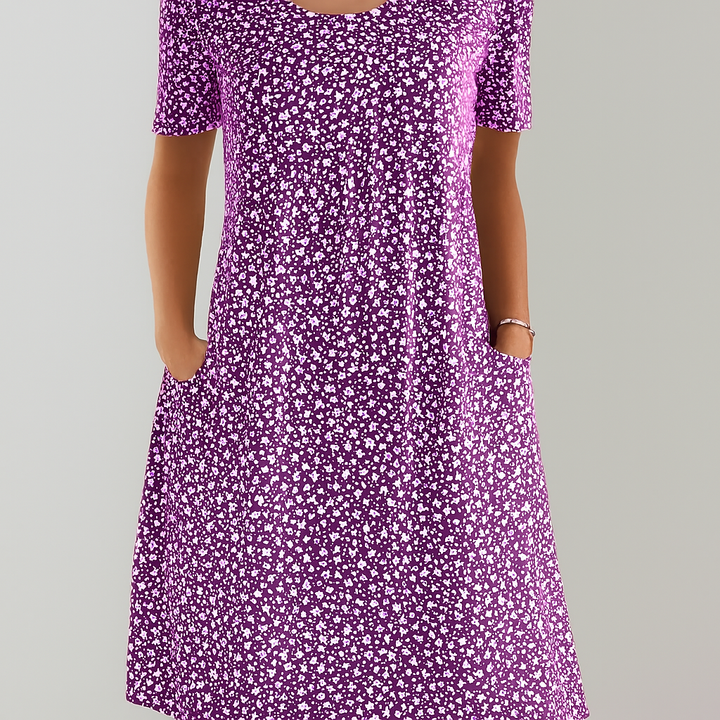 Elegant women's empire waist midi dress, featuring vibrant floral print and functional pockets. Ideal for summer.