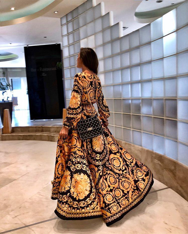 Elegant women's flowy floral boho maxi dress with long sleeves, perfect for vacation wear.
