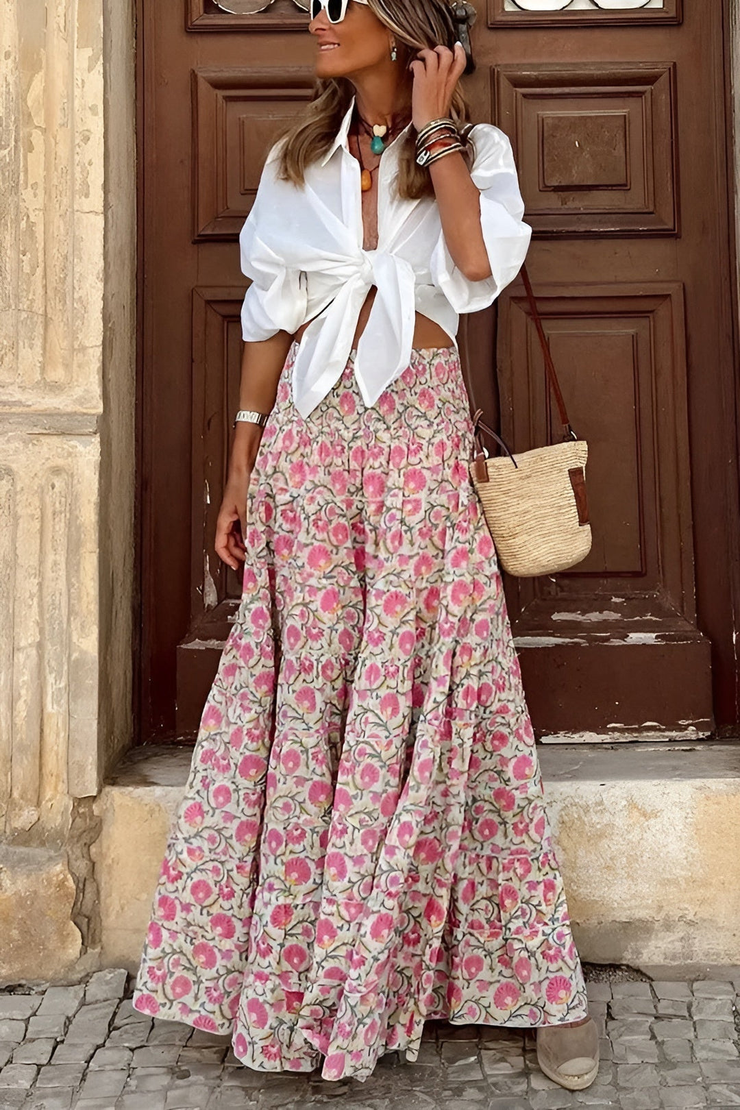 Comfortable women's long floral maxi skirt. Features a smocked waist and a flowy tiered design for casual style.