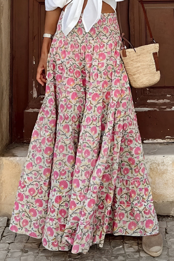 Women's long floral maxi skirt with a comfortable smocked waist. Elegant tiered design, perfect for summer fashion.