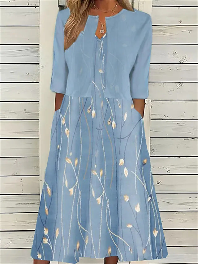 Close-up of a women's vibrant floral midi dress and matching shrug. Perfect ladies' attire for summer casual elegance.
