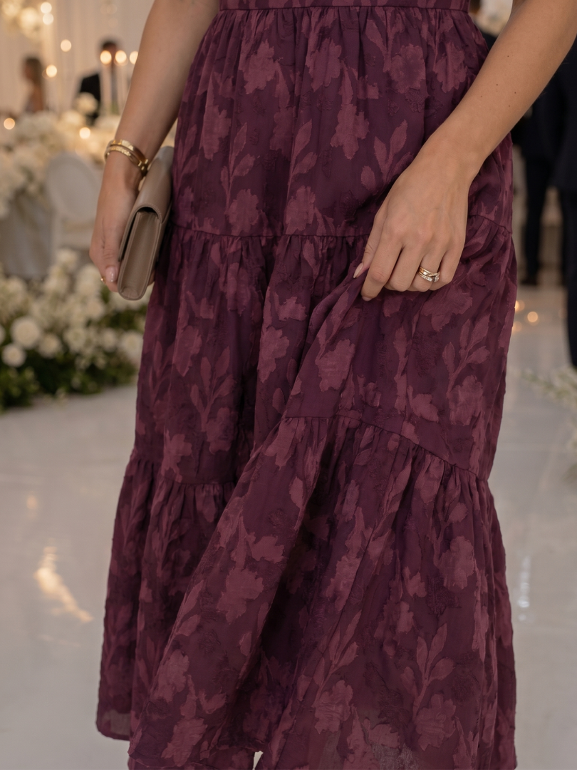 Sophisticated floral midi dress for women with short sleeves and a flowing tiered skirt.