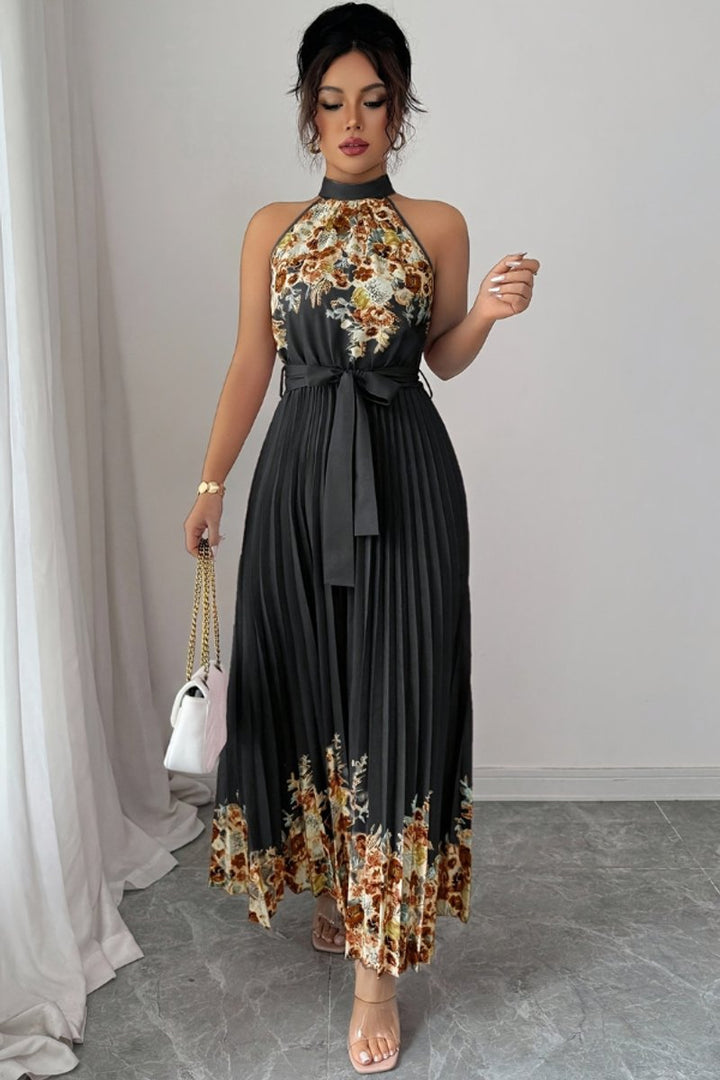 Summer wedding guest dress: floral, pleated, halter neck maxi gown.