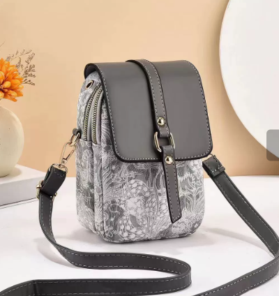 Black floral print crossbody bag, stylish women's shoulder purse, elegant faux leather daily accessory.