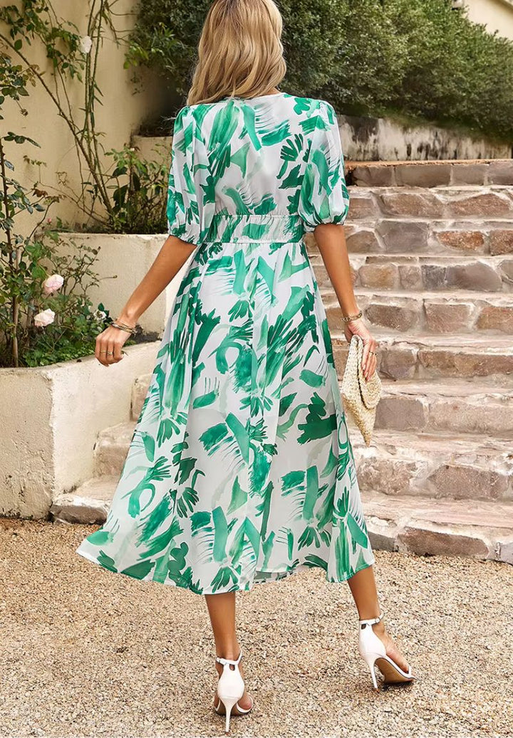 Women's flowing floral print maxi dress, V-neck, puff sleeves, ideal for warm weather style.