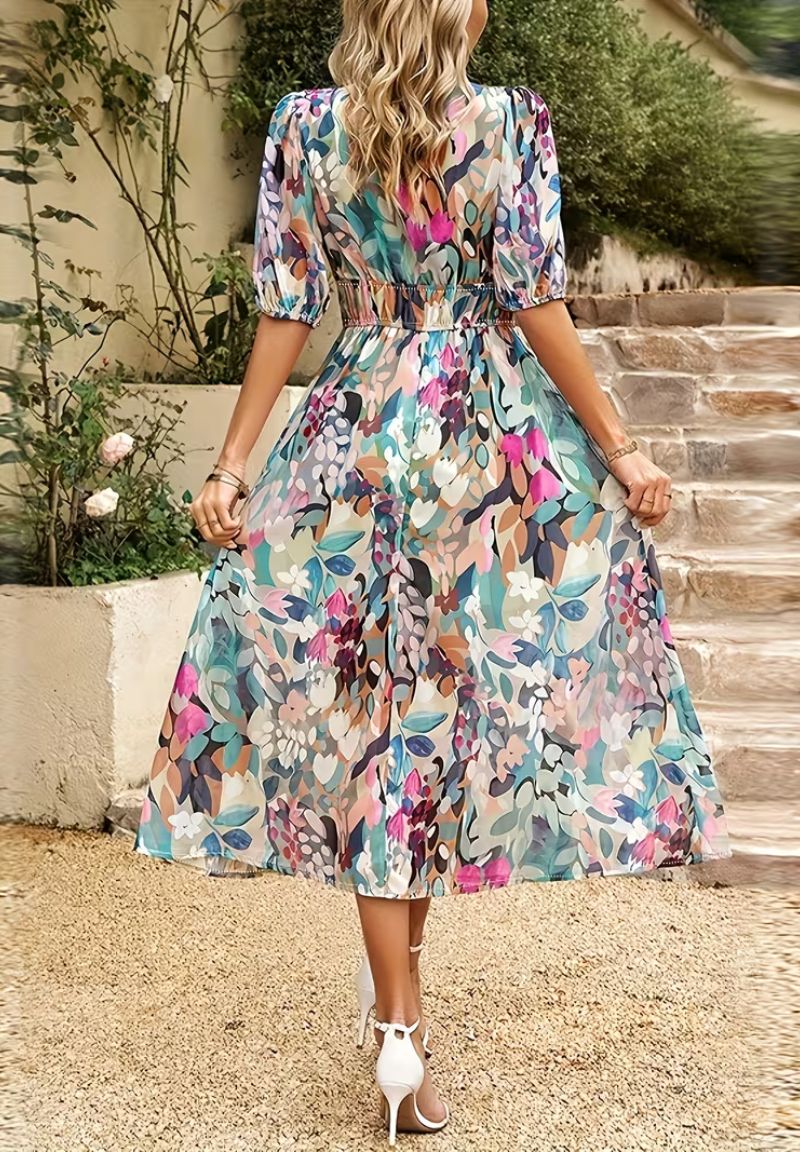 Flowing women's maxi dress with vibrant floral print, V-neck, and chic puff sleeves.