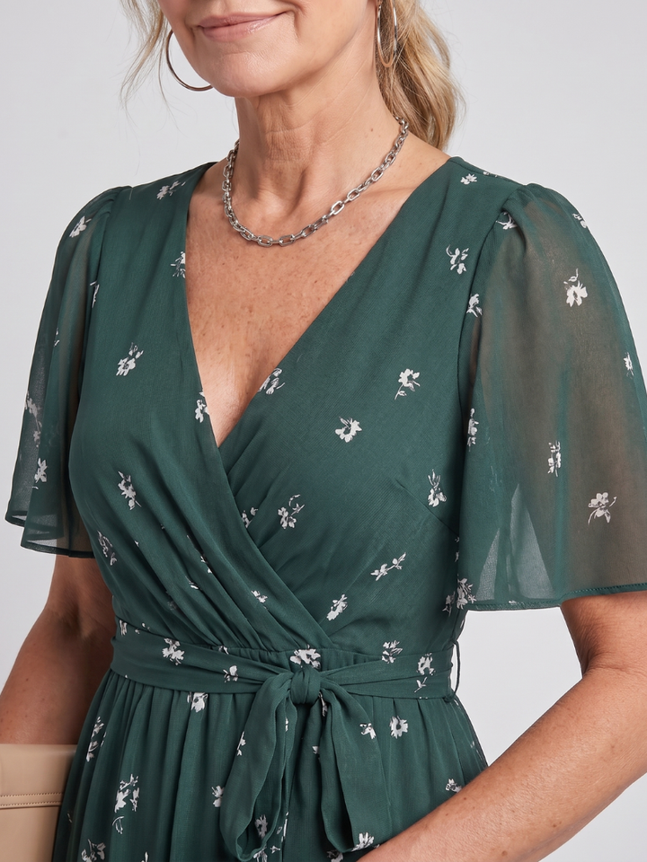 Casual chic women's midi dress with a vibrant floral print, flowy fit, and comfortable flutter sleeves.