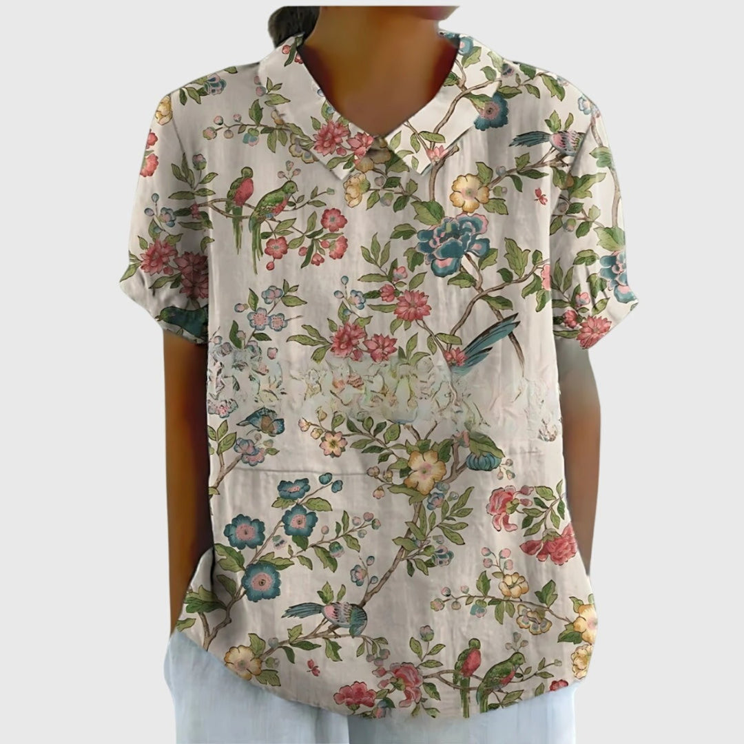 Chic women's collared floral blouse with short sleeves, a stylish choice for smart casual occasions.