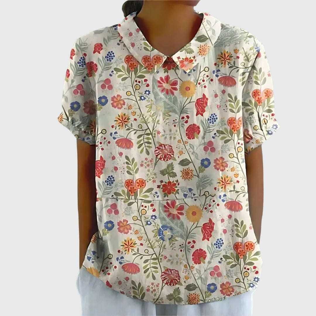 Lightweight women's floral print short sleeve top, collared for a refined look, ideal for warm weather.
