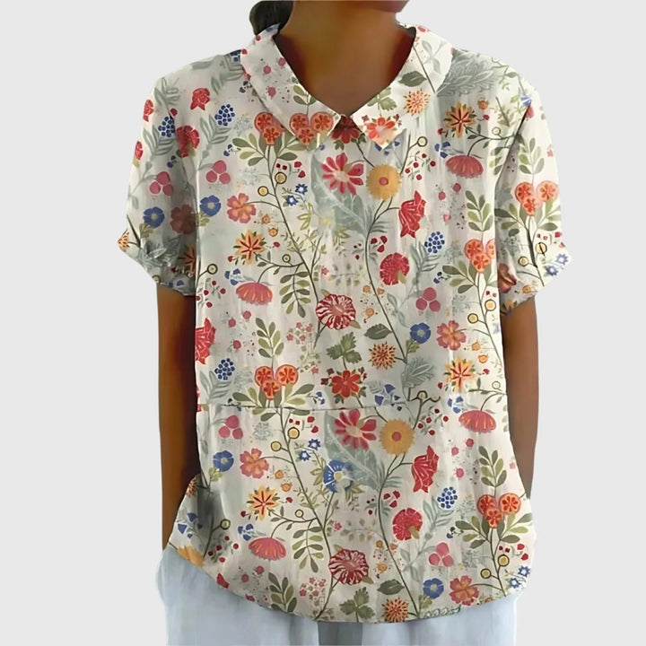 Lightweight women's floral print short sleeve top, collared for a refined look, ideal for warm weather.