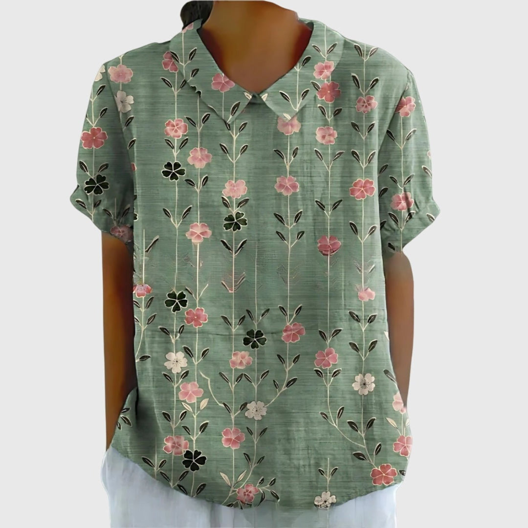 Women's short sleeve collared blouse in a vibrant floral pattern, perfect for a fresh spring outfit.