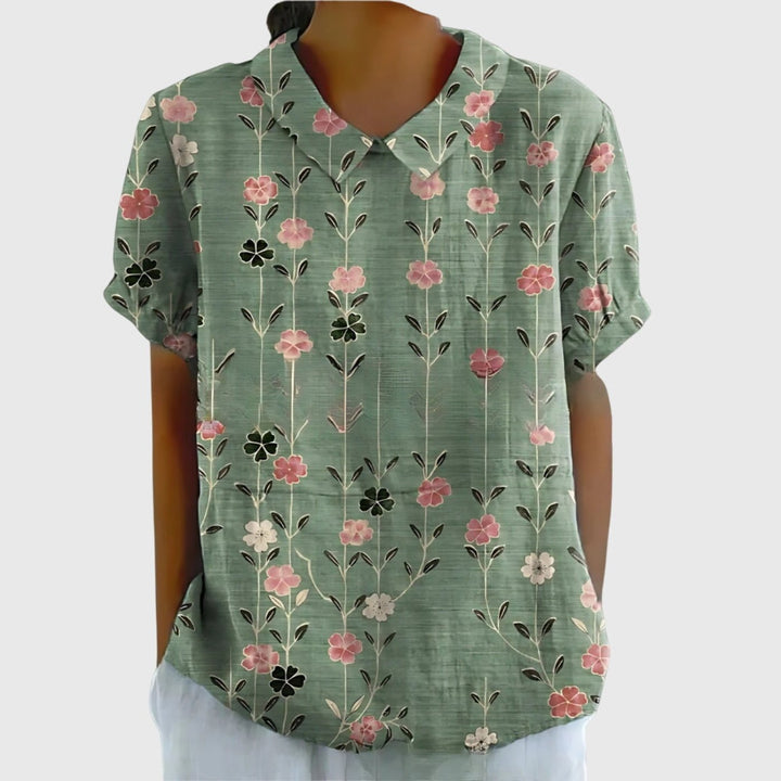 Women's short sleeve collared blouse in a vibrant floral pattern, perfect for a fresh spring outfit.