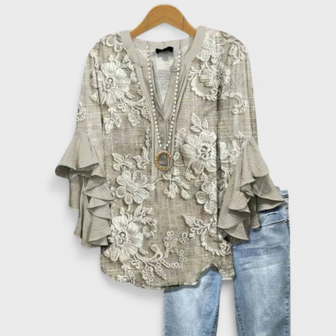Elegant women's floral print blouse, a lightweight V-neck top with stylish ruffle sleeves for various occasions.