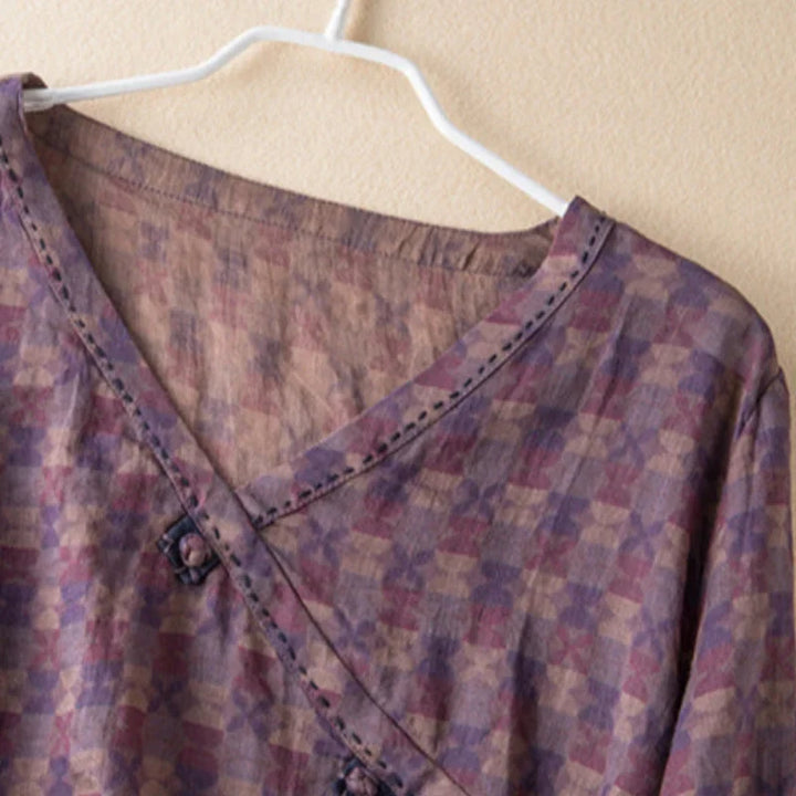Feminine floral print V-neck blouse for women, featuring 3/4 sleeves and a relaxed fit.