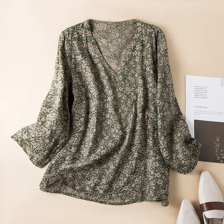 Stylish woman wearing a casual floral V-neck 3/4 sleeve shirt, perfect for summer outings.