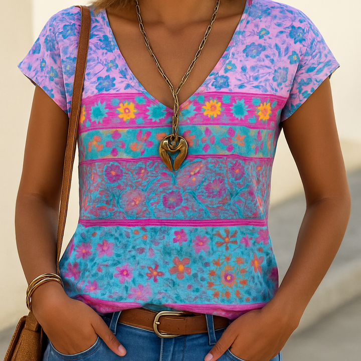 Relaxed fit women's v-neck t-shirt with vibrant floral print. Perfect short sleeve top for casual summer fashion.