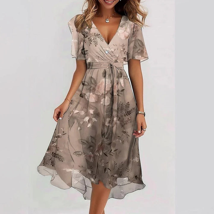Vibrant floral print women's wrap midi dress. Adjustable tie waist & short sleeves. Great for casual or occasion wear.